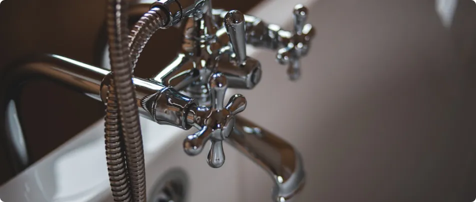 A professional plumber working under a kitchen sink